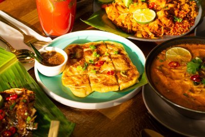 Roti Telur - Flaky, golden-brown Malaysian flatbread with a soft, tender interior, layered with egg and served warm